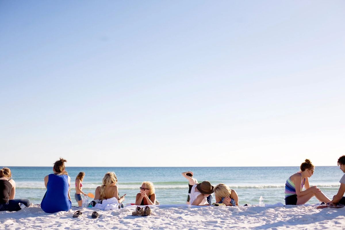 Families enjoying the white-sand beach on Florida's Emerald Coast